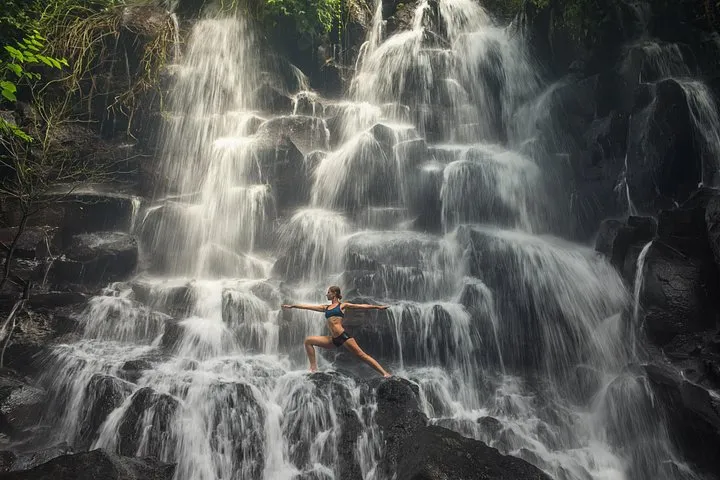 Suwat waterfall pouring into a jungle pool on a Kanto Lampo, Tibumana and Suwat waterfall tour from Ubud