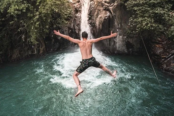A guided jump into the pool below Aling-Aling waterfall in Sambangan, North Bali