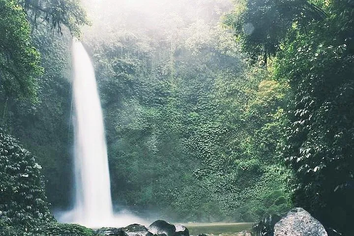 Spray rising from the base of Nungnung waterfall on a private Nungnung and Tanah Lot tour in Bali